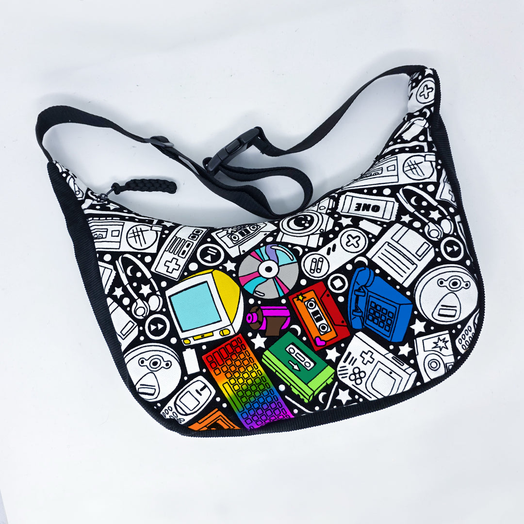 front view of the partially colored retro tech coloring crossbody bag which features a black strap, black corduroy base, and a buckle quick release.
