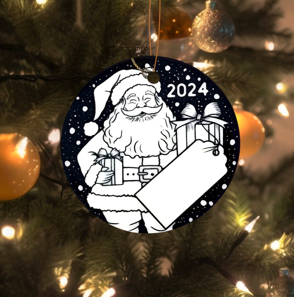 photo of uncolored santa side of the classic Christmas ornament uncolored, hanging on a Christmas tree. 