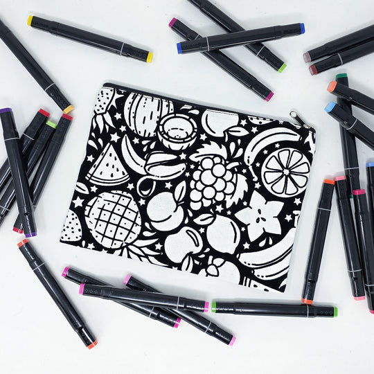 Photo of a black and white flat pencil pouch with lots of colorful markers beside it indicating the customer gets to color it when they receive theirs. This is the same bag as the pencil case - Side B - this bag has images of juicy fruits on it