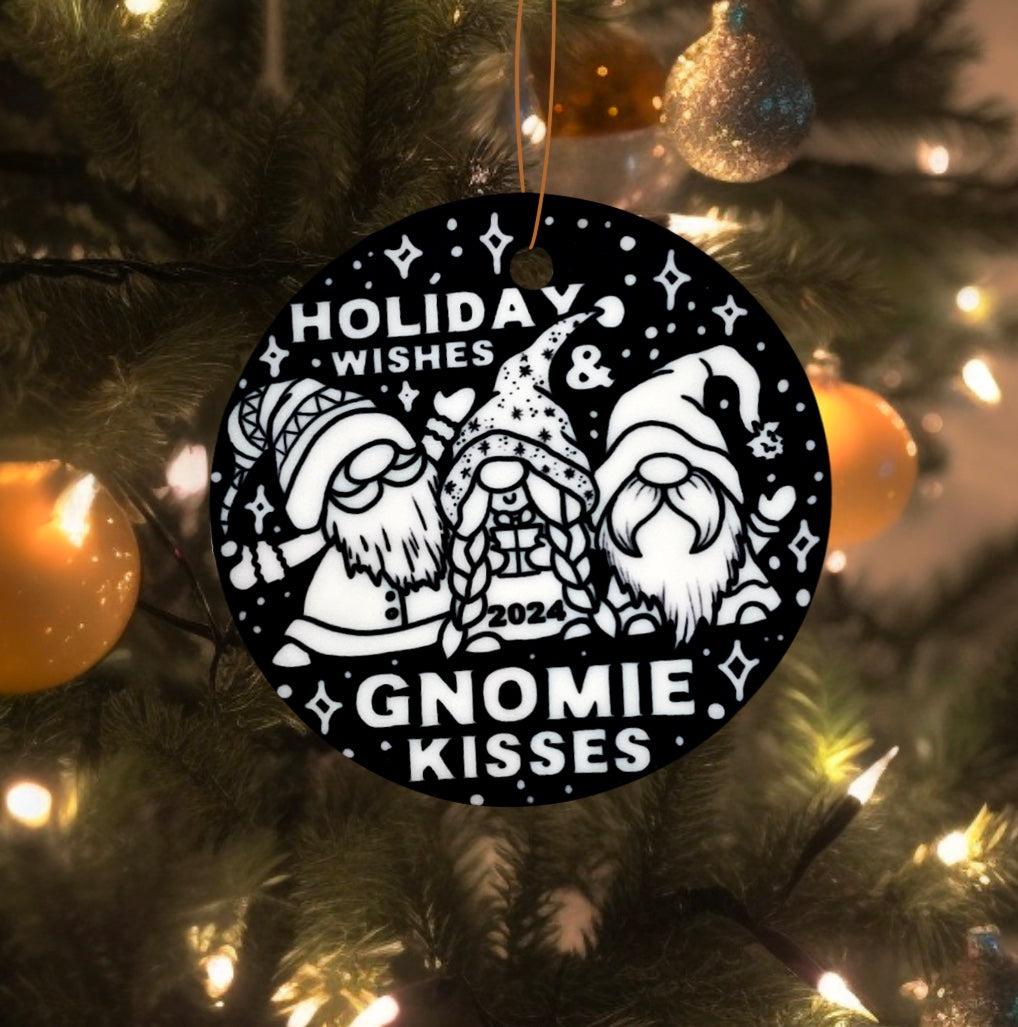 Photo of uncolored side of the gnome-y wishes color your own ornament with 3 cute gnomes that says Holiday Wishes and Gnomie Kisses hanging on a christmas tree