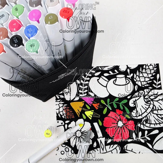Colorful markers in a case with a coloring fabric featuring floral and mushroom designs on a white background.