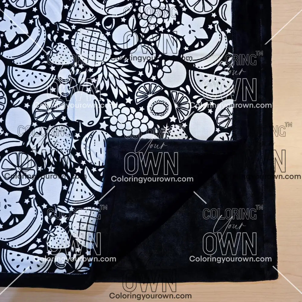 Black and white uncolored fruit variety with pineapples, bananas, watermelons and more patterned blanket with close up view showing black fleece lined underside