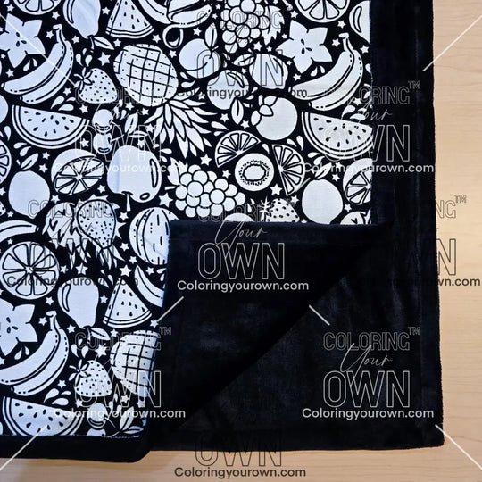Black and white uncolored fruit variety with pineapples, bananas, watermelons and more patterned blanket with close up view showing black fleece lined underside