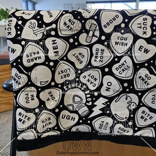 Color Your Own Blanket Anti-Valentines day blanket draped over a couch, not colored, close up