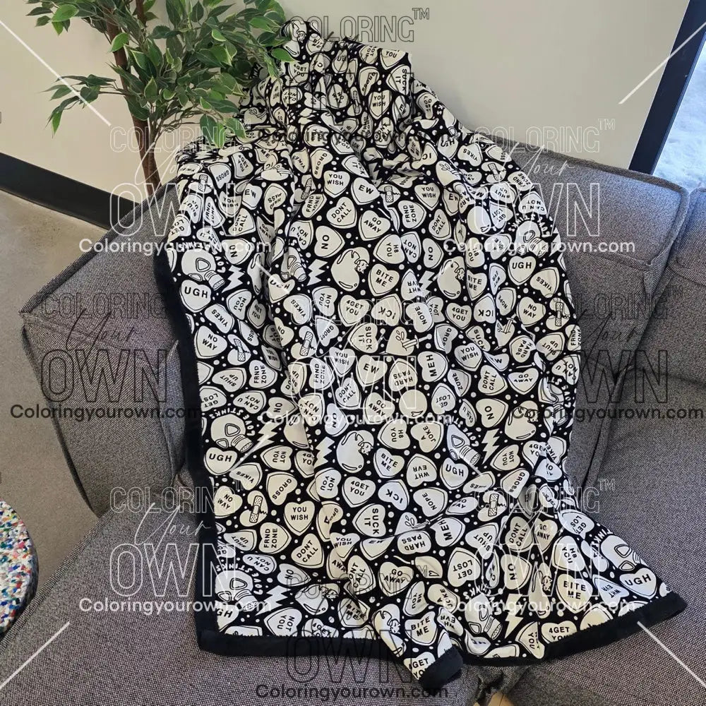 Color Your Own Blanket Anti-Valentines day blanket draped over a couch, not colored