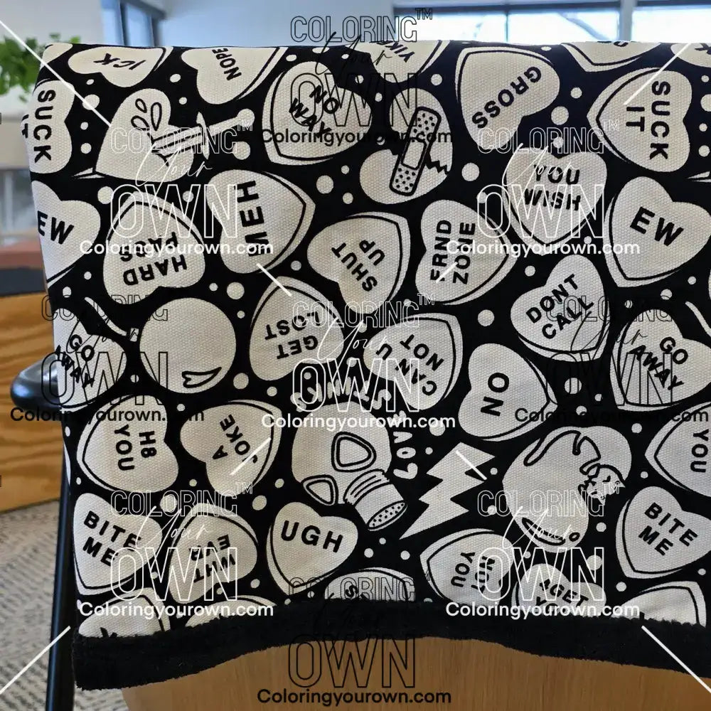 Color Your Own Blanket Anti-Valentines day blanket draped over a couch, not colored, close up