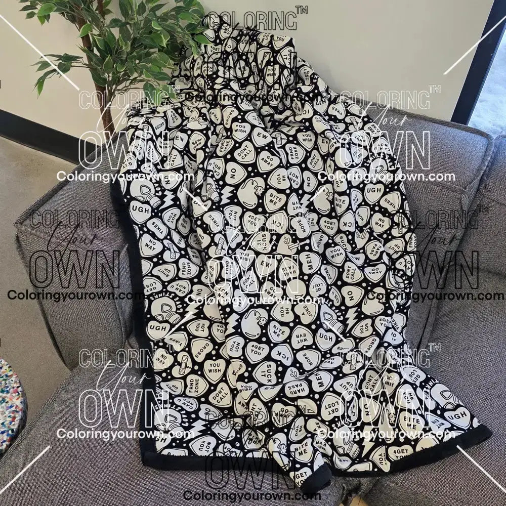 Color Your Own Blanket Anti-Valentines day blanket draped over a couch, not colored
