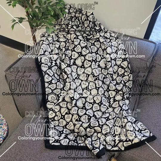 Color Your Own Blanket Anti-Valentines day blanket draped over a couch, not colored