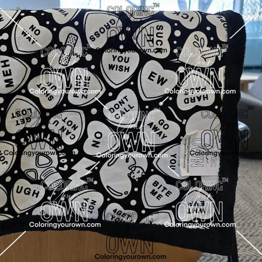 Color Your Own Blanket Anti-Valentines day blanket draped over a couch, not colored, close up
