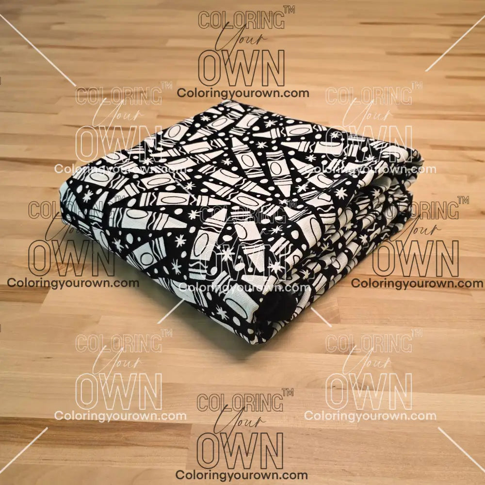 Uncolored many crayon patterned blanket folded on a table