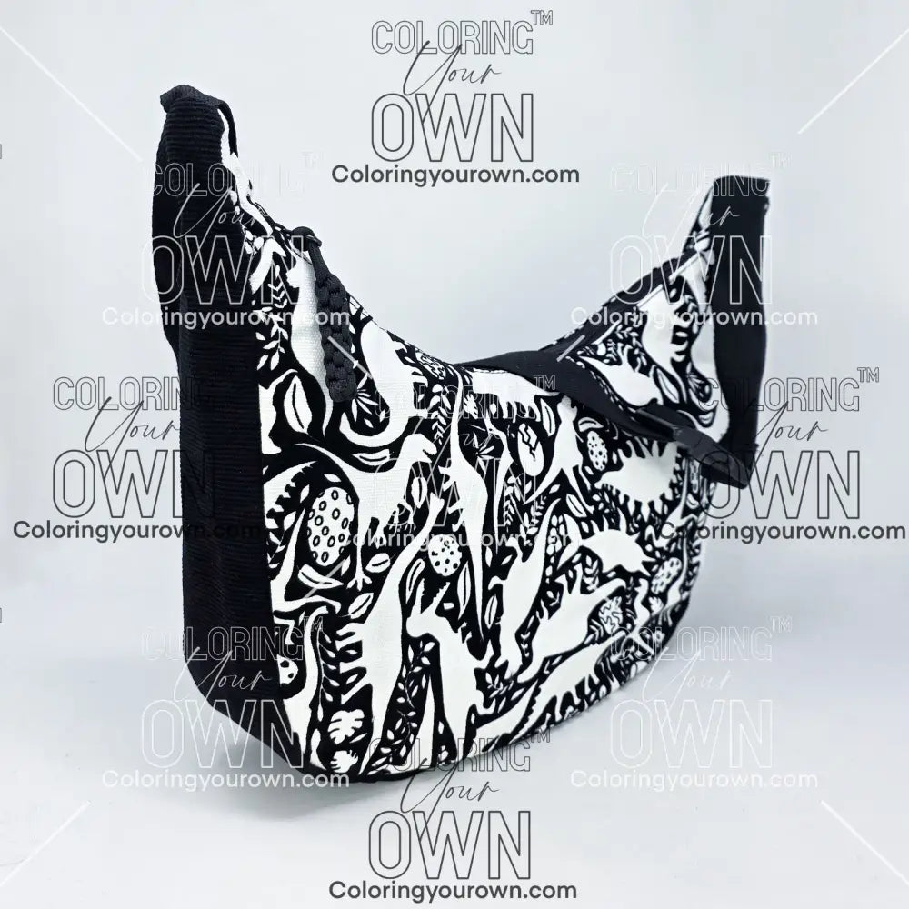 three-quarter view of the dinosaur coloring crossbody bag which features a black strap, black corduroy base, and a buckle quick release.