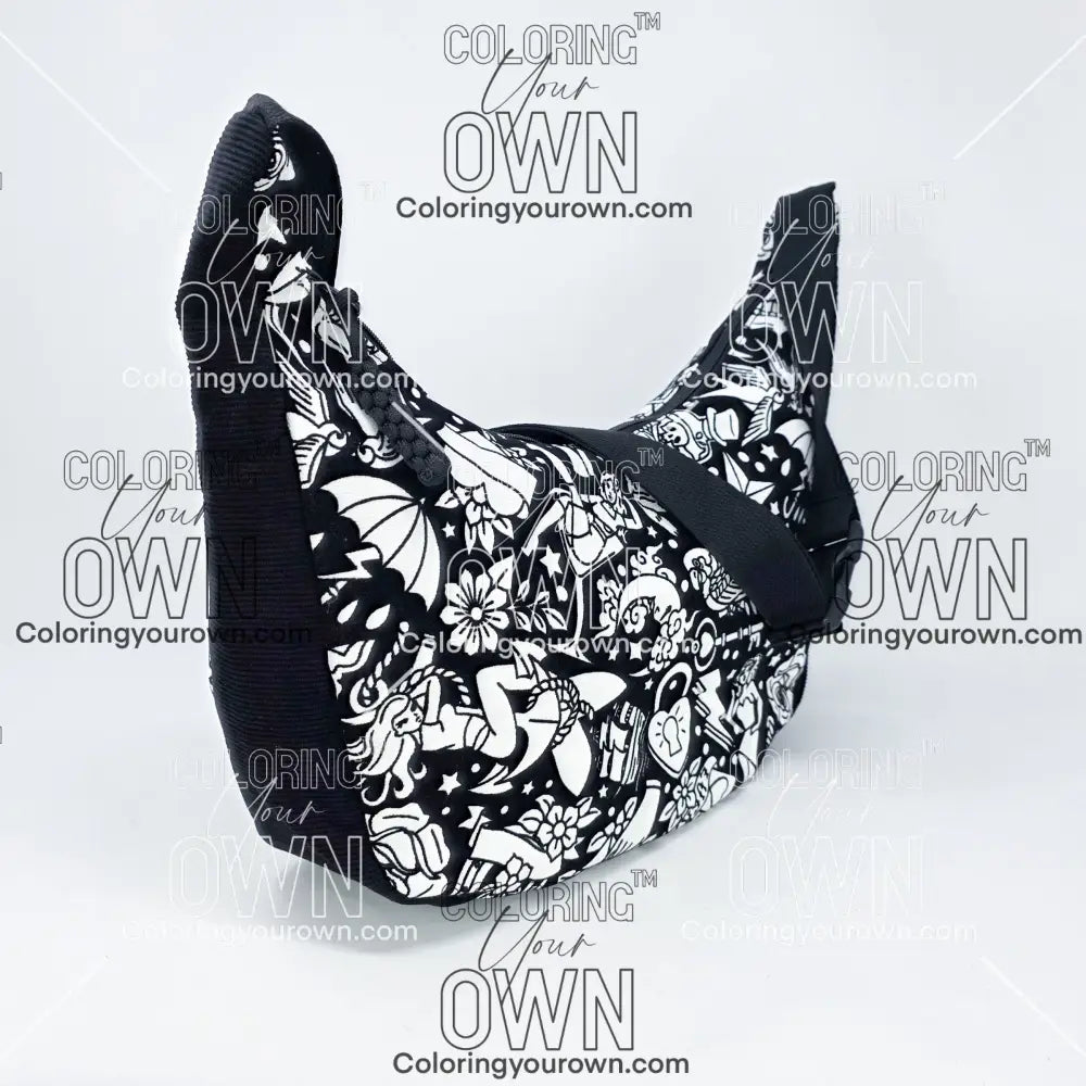 three quarter view of the tattoo coloring crossbody bag which features a black strap, black corduroy base, and a buckle quick release.