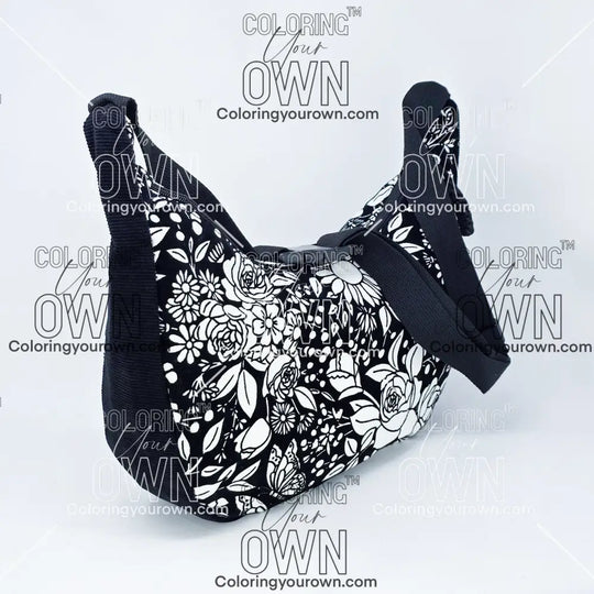 quarter view of the vintage floral coloring crossbody bag partially colored. Black corduroy base with a black strap and quick release buckle. 
