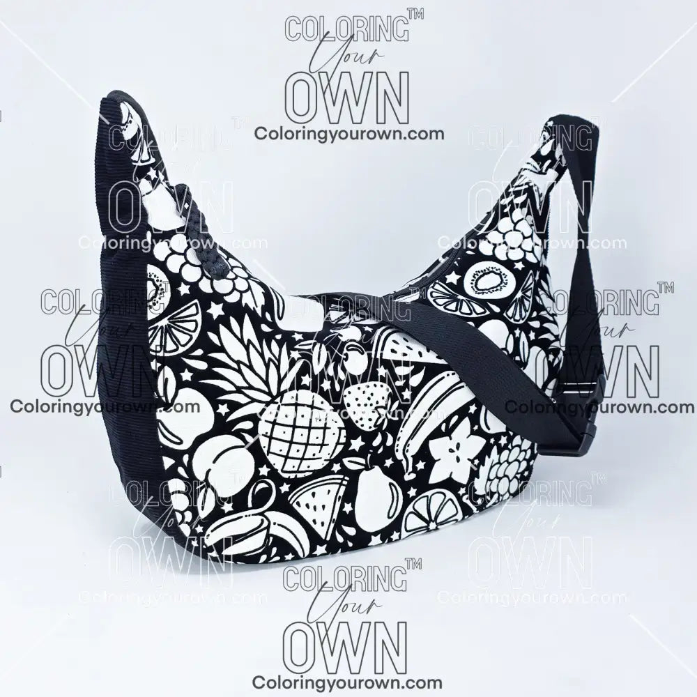 quarter view of the fruit coloring crossbody bag. Black corduroy base with a black strap and quick release buckle. 