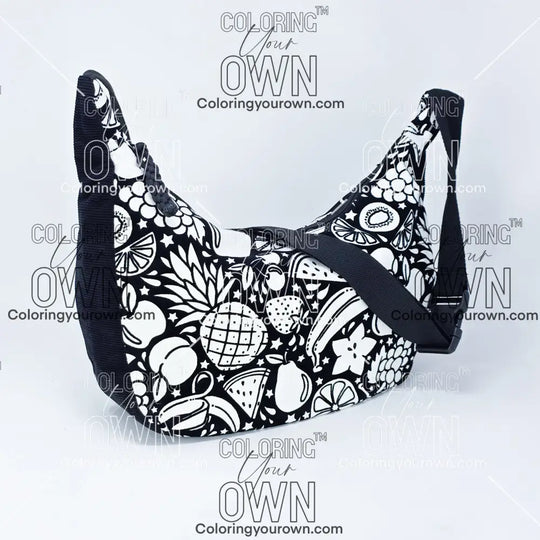 quarter view of the fruit coloring crossbody bag. Black corduroy base with a black strap and quick release buckle. 