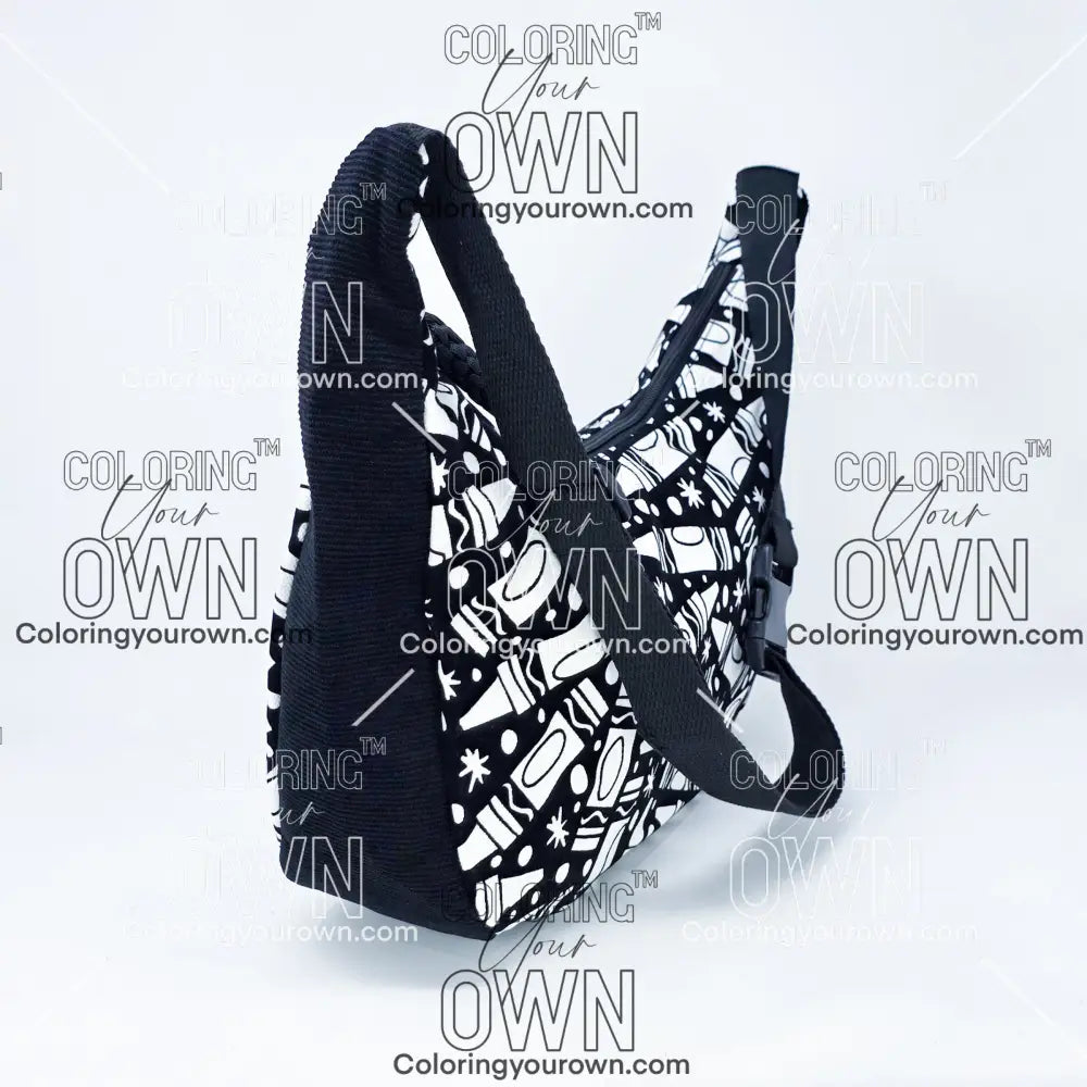 three quarter view of the crayon coloring crossbody bag which features a black strap, black corduroy base, and a buckle quick release.