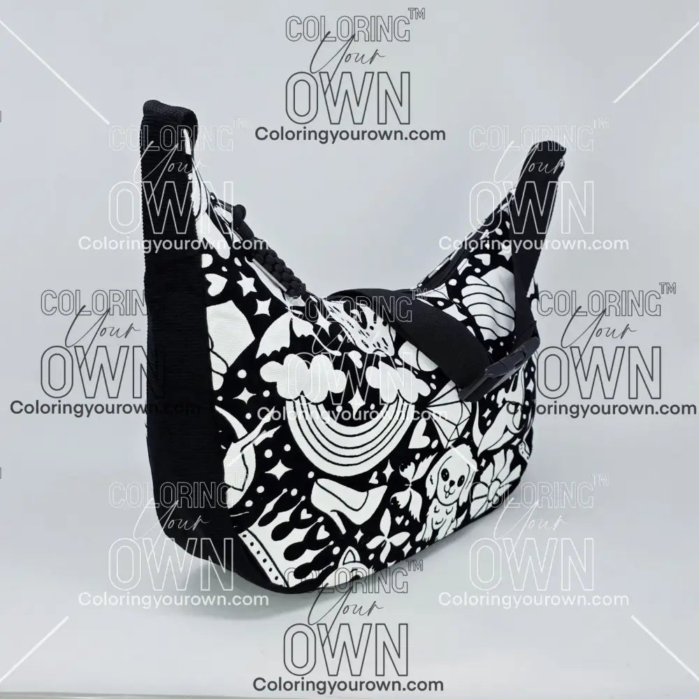 three quarter view of the Happy Doodle 2 coloring crossbody bag which features a black strap, black corduroy base, and a buckle quick release.
