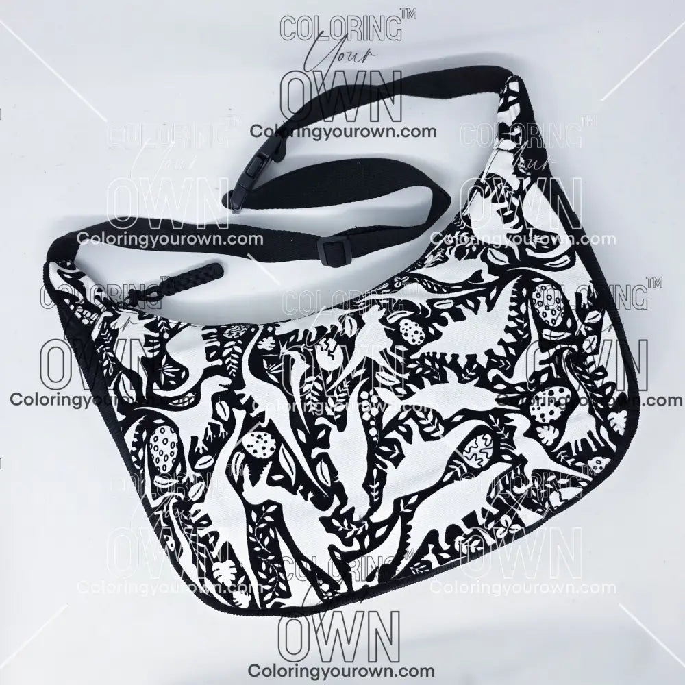 front view of the dinosaur coloring crossbody bag which features a black strap, black corduroy base, and a buckle quick release.