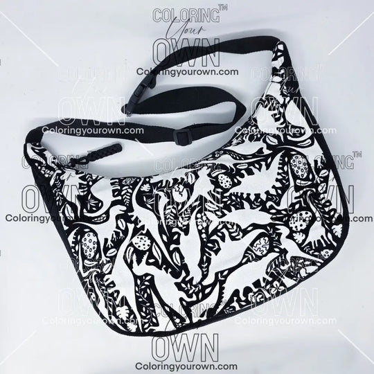 front view of the dinosaur coloring crossbody bag which features a black strap, black corduroy base, and a buckle quick release.