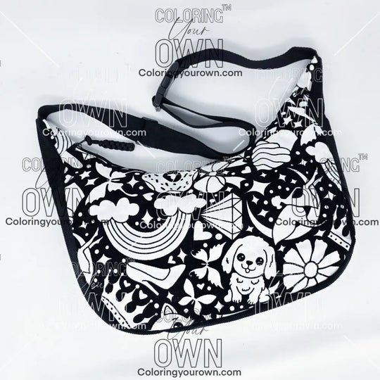 front view of the Happy Doodle 2 coloring crossbody bag which features a black strap, black corduroy base, and a buckle quick release.