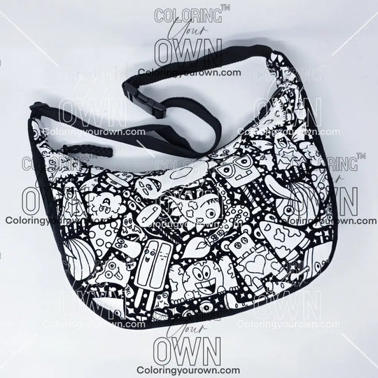 Front view of the silly monsters coloring crossbody bag which features a black strap, black corduroy base, and a buckle quick release.