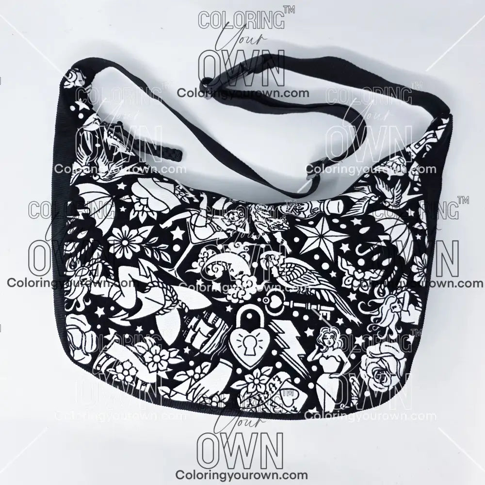 front view of the tattoo coloring crossbody bag which features a black strap, black corduroy base, and a buckle quick release.