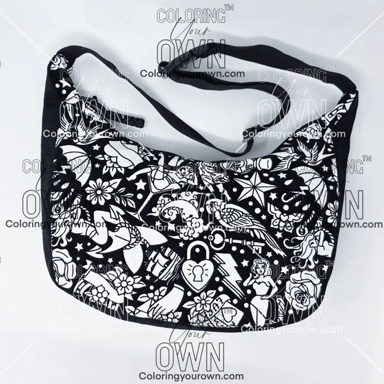 front view of the tattoo coloring crossbody bag which features a black strap, black corduroy base, and a buckle quick release.