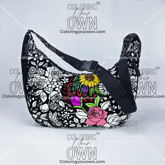front facing view of the vintage floral coloring crossbody bag partially colored. Black corduroy base with a black strap and quick release buckle. 
