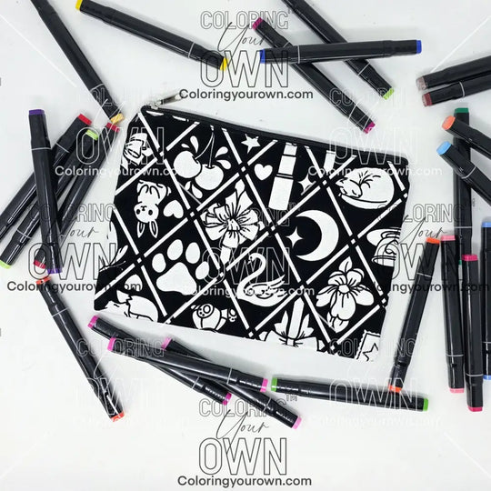 Photo of a black and white flat pencil pouch with lots of colorful markers beside it indicating the customer gets to color it when they receive theirs. This is the same bag as the pencil case and makeup bag - Side B - this bag has images of Coquette-inspired illustrations including a swan, a paw print, bows, a moon, stars, a bunny on it cherries and more
