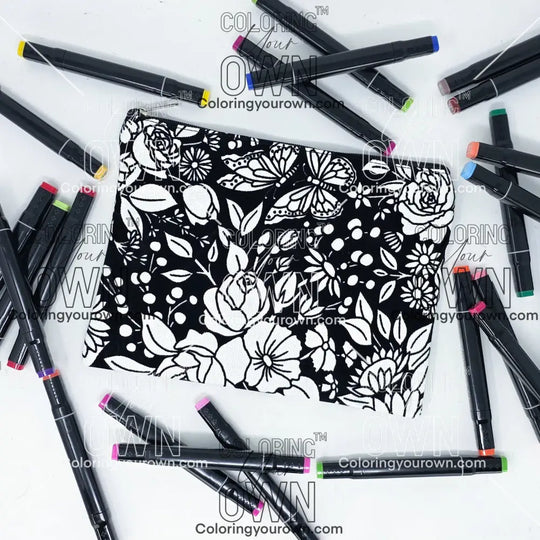Photo of a black and white flat pencil pouch with lots of colorful markers beside it indicating the customer gets to color it when they receive theirs. This is the same bag as the pencil case - Side A - this bag has images of vintage flowers on it