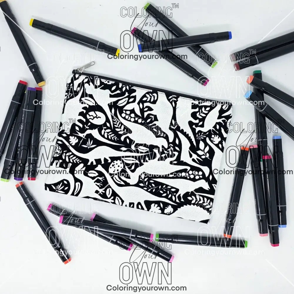Photo of a black and white flat pencil pouch with lots of colorful markers beside it indicating the customer gets to color it when they receive theirs. This is the same bag as the pencil case and makeup bag - Side A - this bag has images of dinosaurs, foliage, and eggs