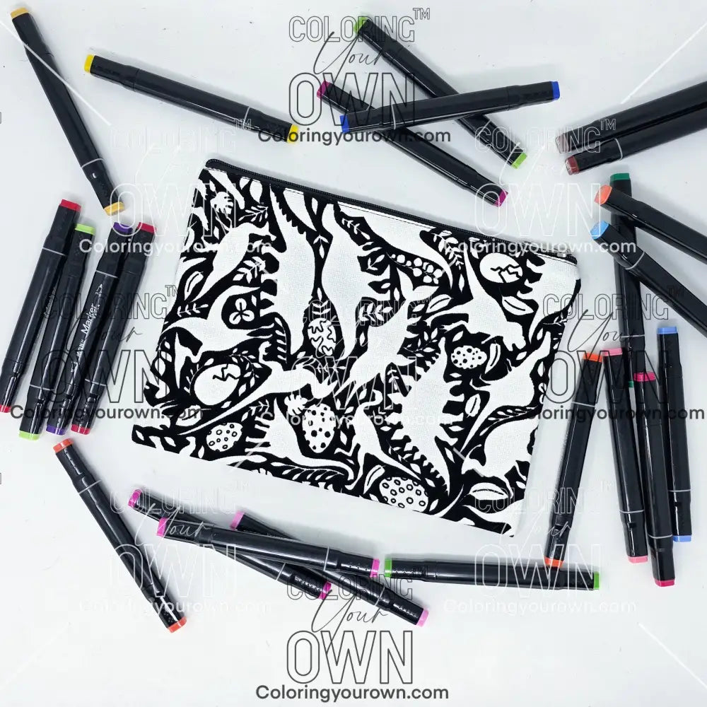 Photo of a black and white flat pencil pouch with lots of colorful markers beside it indicating the customer gets to color it when they receive theirs. This is the same bag as the pencil case and makeup bag - Side A - this bag has images of dinosaurs, foliage, and eggs