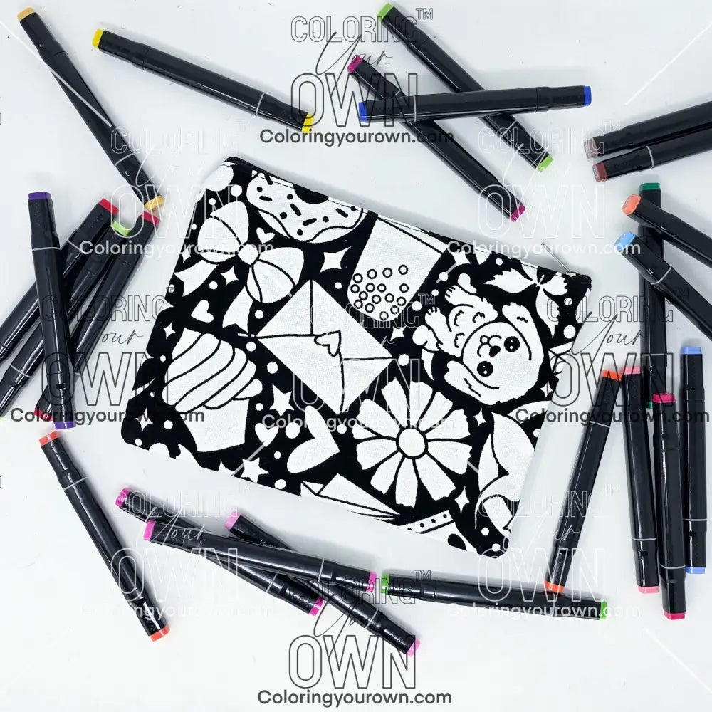 Photo of a black and white flat pencil pouch with lots of colorful markers beside it indicating the customer gets to color it when they receive theirs. This is the same bag as the pencil case and makeup bag - Side B - this bag has images of happy doodles on it