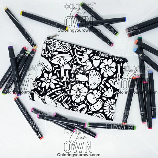 Photo of a black and white zipper pouch with lots of colorful markers beside it indicating the customer gets to color it when they receive theirs. mushroom 2 design