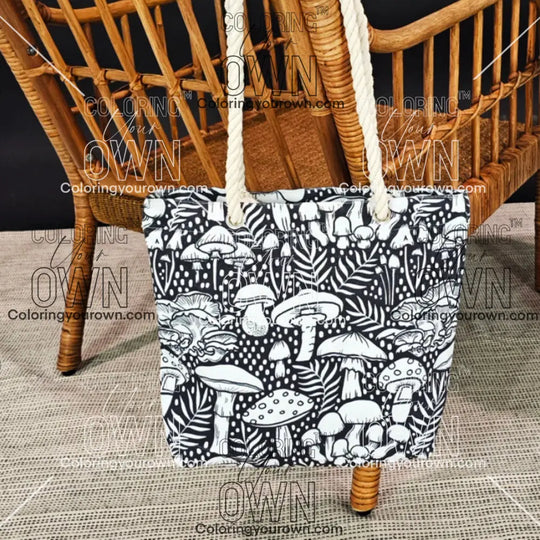 photo of a mushroom color your own tote, uncolored hanging on the back of a wicker chair
