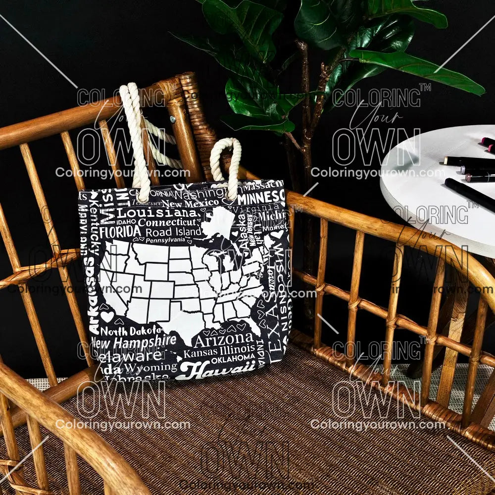 photo of a color your own tote with a map of the USA on it sitting on a wicker chair.