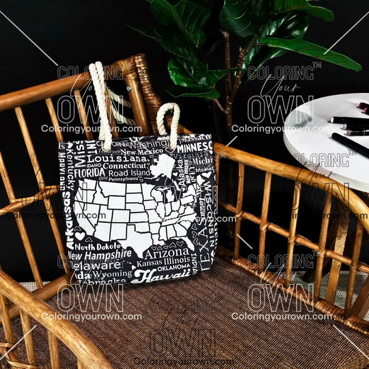 photo of a color your own tote with a map of the USA on it sitting on a wicker chair.