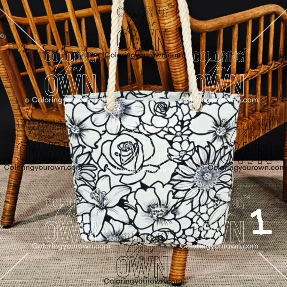 photo of an uncolored floral canvas tote hanging on the back of a wicker chair