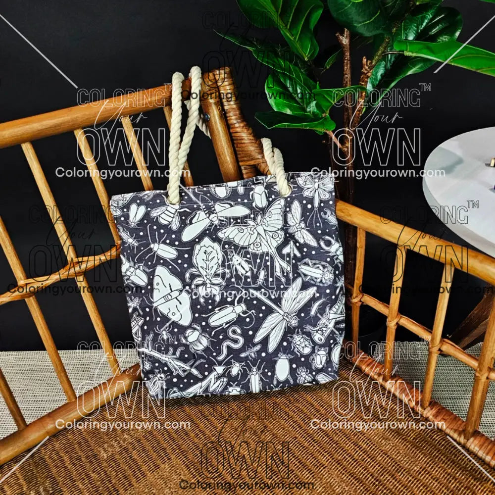 photo of an uncolored color your own bug tote sitting on a wicker chair