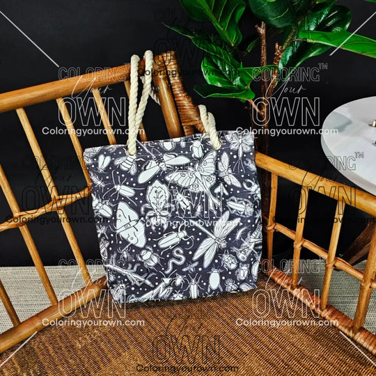 photo of an uncolored color your own bug tote sitting on a wicker chair